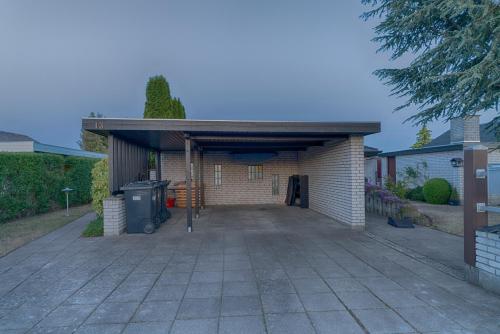 a detached garage with a driveway in a house at HvideHus Aunslev in Nyborg