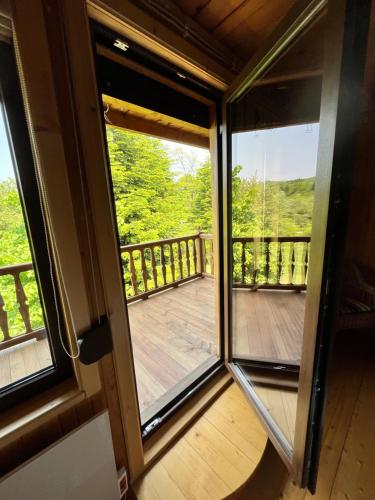 a view from the front door of a cabin with a deck at House Girska Rika in Korchin
