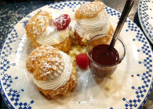 une assiette de pâtisseries avec de la crème fouettée et des fruits rouges dans l'établissement La Maison de Philomène, à Corme-Royal
