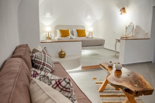 a living room with a couch and a coffee table at Sun Angelos Oia - Luxury Cave Suites in Oia
