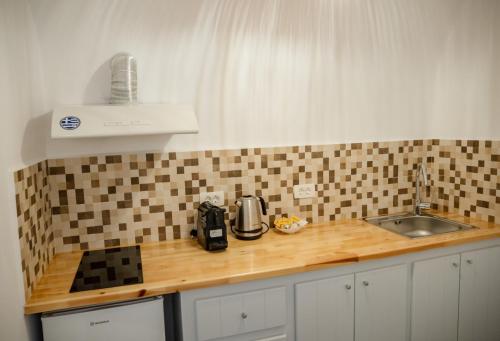 a kitchen with a counter top with a sink at Sun Angelos Oia - Luxury Cave Suites in Oia