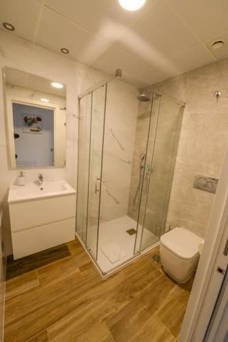 a bathroom with a shower and a toilet and a sink at Apartment Sunset Cliffs Poniente in Benidorm