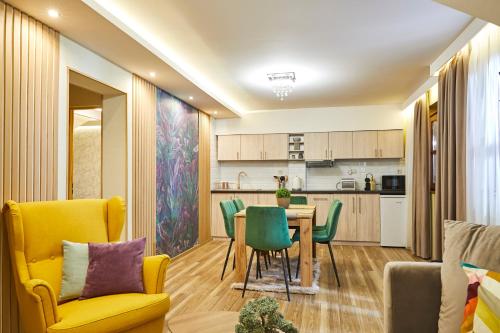 a kitchen and dining room with a table and chairs at Garden Villa Zsóry in Mezőkövesd