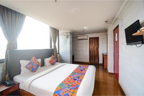 a bedroom with a large white bed in a room at FabHotel Raj Darbar in Salua