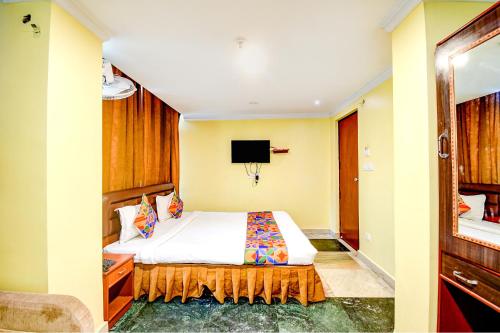 a hotel room with a bed and a tv at FabHotel Raj Darbar in Salua