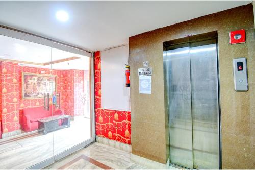 a lobby with a glass door in a building at FabHotel Raj Darbar in Salua