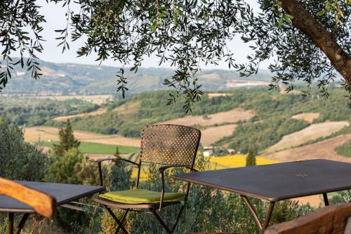 two chairs and a table on top of a hill at Country House Art and Garden in Monte Antico