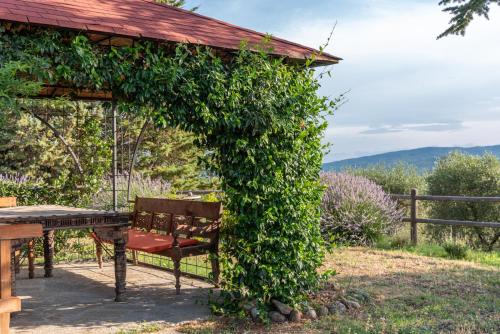a gazebo with a table and a bench at Country House Art and Garden in Monte Antico