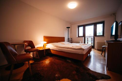 a bedroom with a large bed and a window at YURA vila Čeladná - ZDARMA SAUNA A VNITŘNÍ BAZÉN V YURA HOTELU in Čeladná