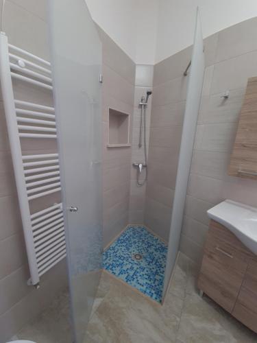 a bathroom with a shower with a glass door at Casa Vacanza Fontana in Manduria