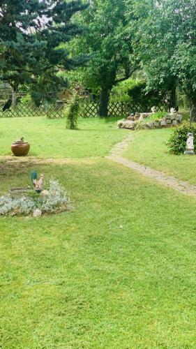 a person sitting on a bench in the grass at La petite maison de Paule in Amilly
