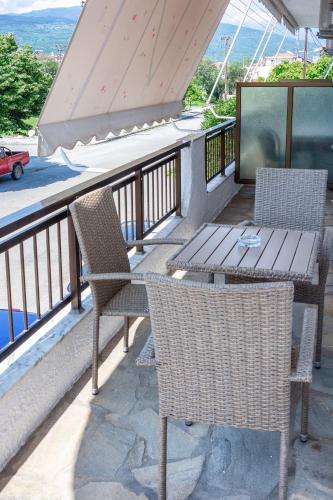 a patio with two chairs and a table on a balcony at Brunis Apartments in Nei Poroi