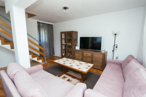 a living room with a couch and a table at Weeksa Vacation Home in Duga Resa
