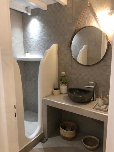 a bathroom with a sink and a mirror at Francesca Secret in Mikonos