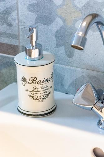 a bottle of balins sitting on top of a bathroom sink at Brunis Apartments in Nei Poroi
