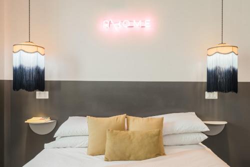 a bed with pillows and a sign that reads acute at MARCANTONIO HOME ROME - Vatican - in Rome