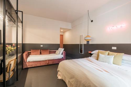 a bedroom with two beds and a couch at MARCANTONIO HOME ROME - Vatican - in Rome