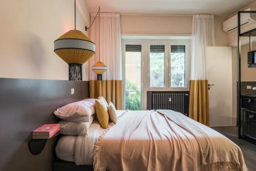 a bedroom with a bed and a lamp at MARCANTONIO HOME ROME - Vatican - in Rome