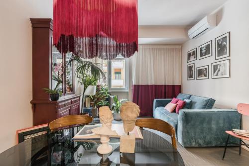 a living room with a table and a couch at MARCANTONIO HOME ROME - Vatican - in Rome