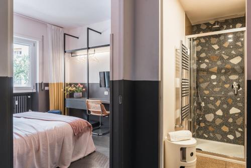 a bedroom with a bed and a bathroom with a shower at MARCANTONIO HOME ROME - Vatican - in Rome