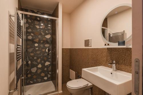a bathroom with a toilet and a sink and a shower at MARCANTONIO HOME ROME - Vatican - in Rome