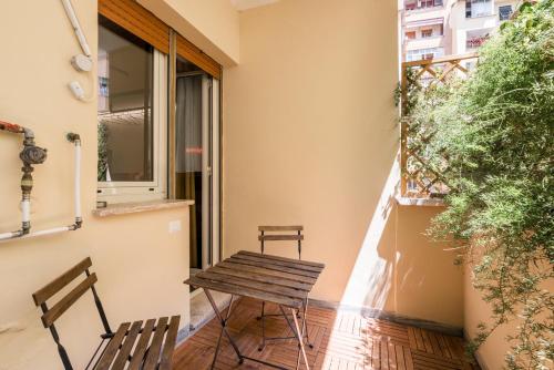a small balcony with two chairs and a table at MARCANTONIO HOME ROME - Vatican - in Rome