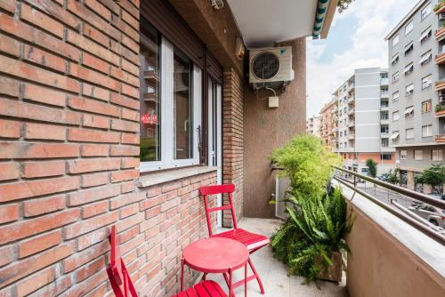 two red chairs and a red table on a balcony at MARCANTONIO HOME ROME - Vatican - in Rome