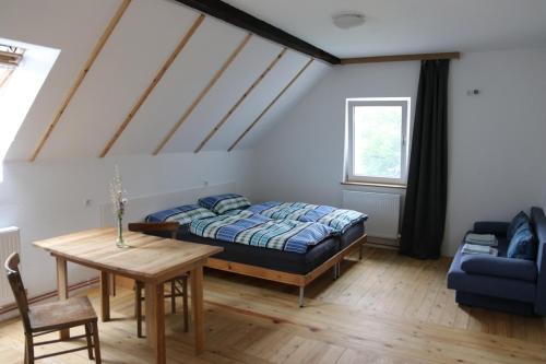 a bedroom with a bed and a table at Ferienhaus Karl in Bleiburg