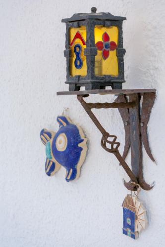 a bird feeder with a blue fish hanging on a wall at Brunis Apartments in Nei Poroi