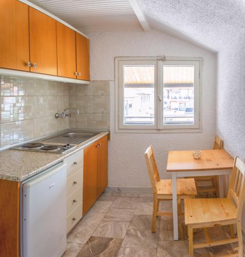 a kitchen with a table and a table and a table and chairs at Brunis Apartments in Nei Poroi