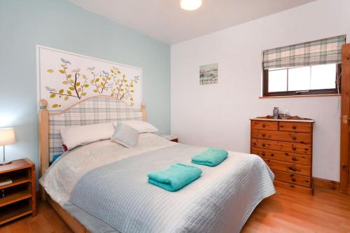 a bedroom with a bed with two pillows on it at Garden cottage in South Collingham