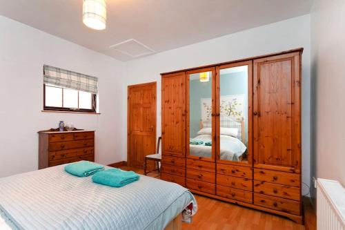 1 dormitorio con 1 cama y vestidor en Garden cottage, en South Collingham