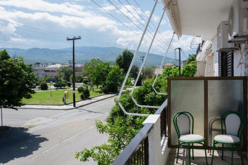 a balcony with chairs and a view of a street at Brunis Apartments in Nei Poroi