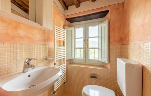 a bathroom with a sink and a toilet and a window at Cozy Home In Orbicciano With Wifi in Monsagrati
