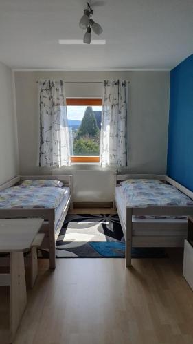 a room with two beds and a window at Gästezimmer Weinberg in Steinau an der Straße