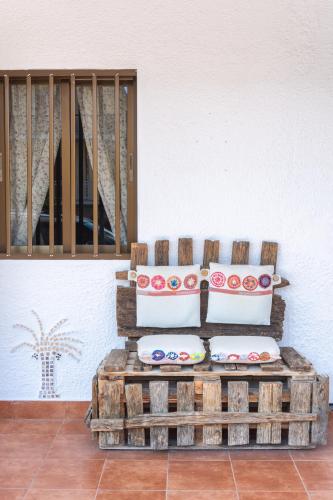 a chair with pillows sitting in a room at Brunis Apartments in Nei Poroi