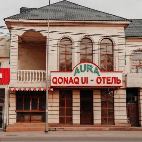 a building with a sign on the front of it at Aura Almaty in Almaty