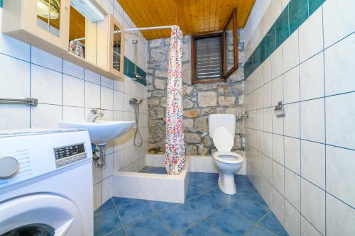 a bathroom with a toilet and a sink at Betlehem & Nazaret cottage on Krk island in Krk