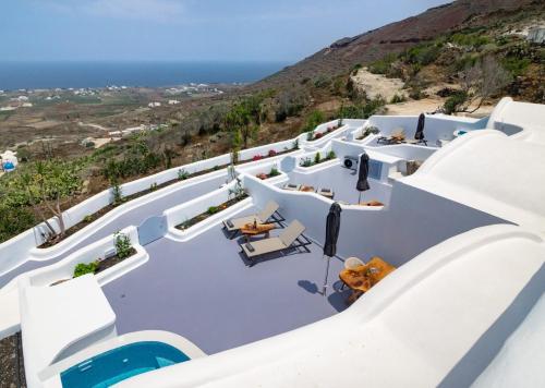 a view of the white buildings and the ocean at Sun Angelos Oia - Luxury Cave Suites in Oia