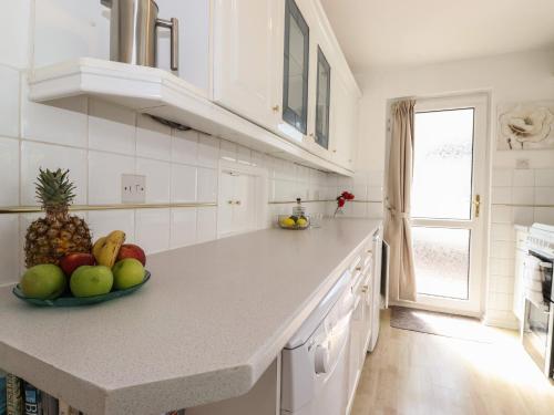 a kitchen with a bowl of fruit on a counter at Oaklea in Keswick