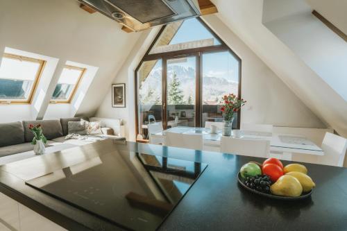 a glass table in a living room with a bowl of fruit at VisitZakopane - Superior Apartment in Zakopane