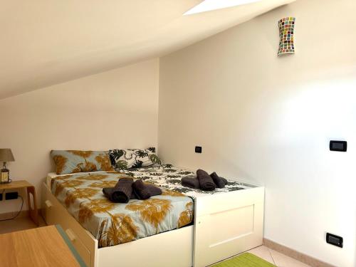 a bedroom with a bed in a white room at Mavericklodge in LʼAquila