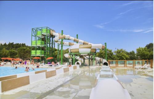 un parc aquatique avec un toboggan et une piscine dans l'établissement Mobil-home 6 personnes - Camping La Falaise 4* / Piscine / Club enfants / SPA / Restaurant / Animations, à Narbonne