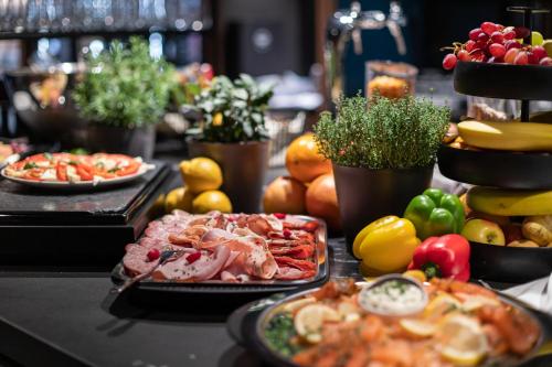 a buffet with different types of food on a table at Hotel Weißes Ross in Kulmbach