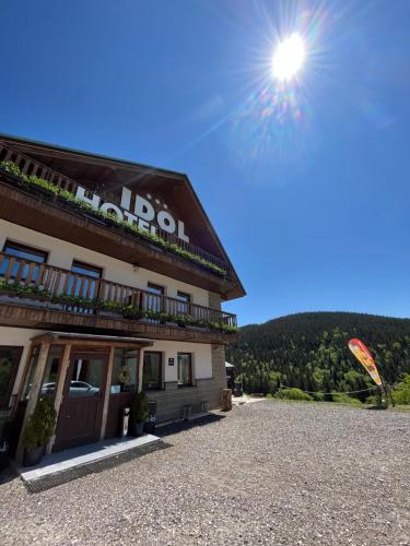 a kite is flying in front of a building at Horský Hotel Idol in Horni Misecky