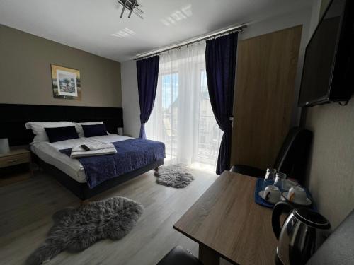 a bedroom with a bed and a large window at Villa Mors in Mielno