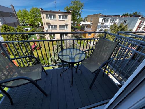 a balcony with two chairs and a table on it at Villa Mors in Mielno