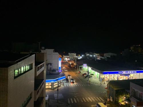 a night view of a city street with buildings at 秀舍民宿Showhouse in Hengchun