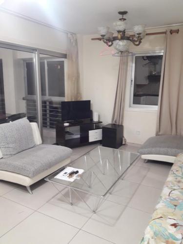 a living room with a glass table and a couch at Nicosia City Centre Apartment in Nicosia