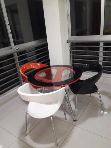 a glass table and two chairs on a balcony at Nicosia City Centre Apartment in Nicosia